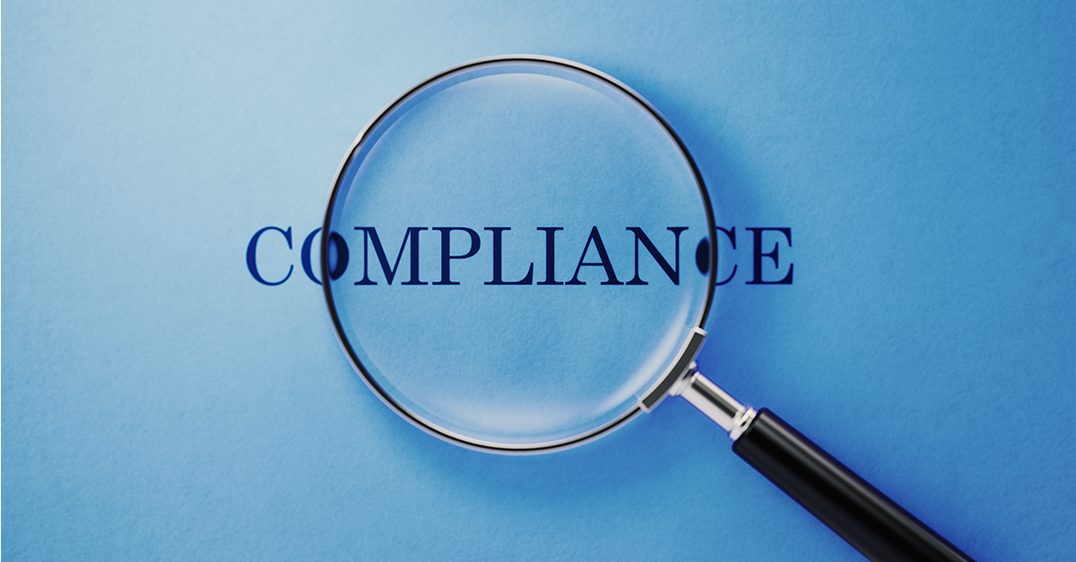 Forstørrelsesglass over ordet compliance